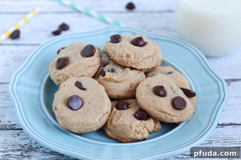 A batch of freshly baked easy Bisquick chocolate chip cookies on a white plate.