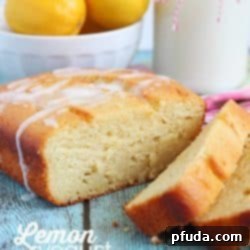 Lemon cake sliced with a glaze drizzled over the top.