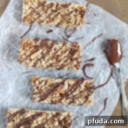 Effortless No-Bake Granola Bars 2 Top view of Easy No-Bake Granola Bars with oats, almonds and coconut with a delicious chocolate & Nutella drizzle on top + 43 Healthy Snack Ideas