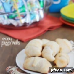 Simple & delicious Pizza Rolls made from ready-made pizza dough, mozzarella sticks, pizza sauce and pepperoni all rolled together in a fun little bite and served with a refreshing Capri Sun! #ad