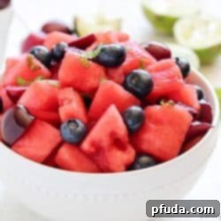 Watermelon Fruit Salad with cherries, blueberries and a delicious mint-lime dressing. Easy, fresh and the perfect summer side dish!