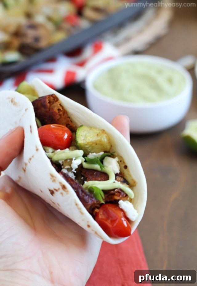 A trio of Roasted Vegetable and Black Bean Tacos, elegantly plated and ready to be enjoyed.