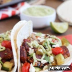 Freshly prepared Roasted Vegetable & Black Bean Tacos, showcasing the vibrant colors and toppings.