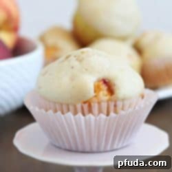 One Homemade Peach Muffin on a cupcake tray.