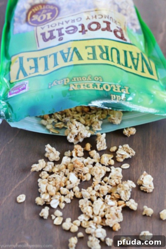 Close-up of a layered parfait featuring creamy yogurt, fresh fruit, and crunchy Nature Valley Protein Granola, offering sustained energy. #ad #naturevalleygranola