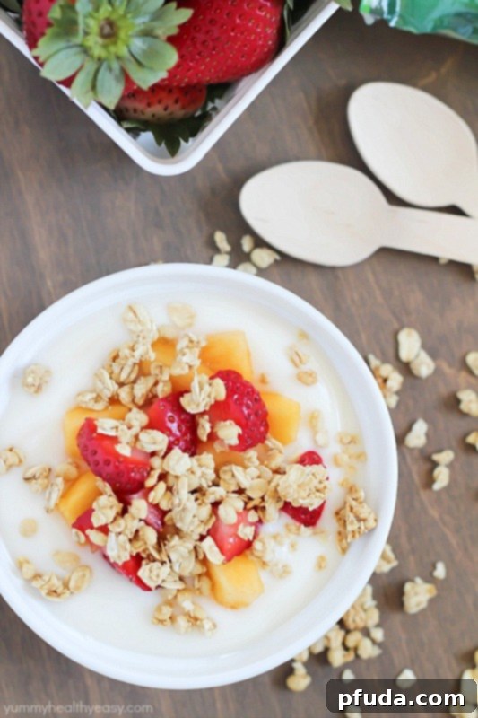 A beautifully arranged bowl of fruit, yogurt, and Nature Valley Protein Granola parfait, emphasizing its role as a delicious and nutritious meal option. #ad #naturevalleygranola