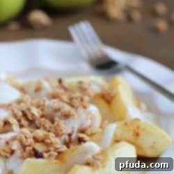 Baked Apples tossed in maple syrup and served with spiced yogurt and granola. Easy and healthy dessert, snack or breakfast!