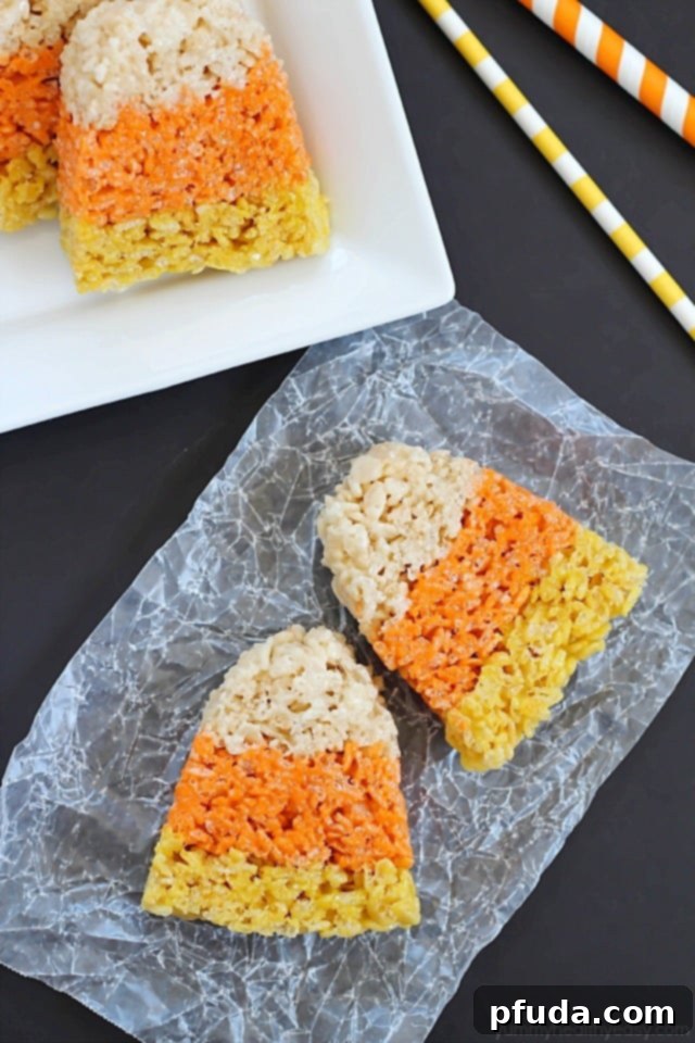 Close-up of a perfectly shaped Candy Corn Rice Krispie Treat, showing distinct layers