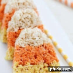 The cutest little Candy Corn Rice Krispie Treats make a fun Halloween snack and/or treat!