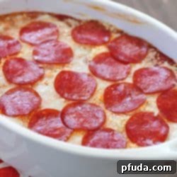 The most unbelievable pizza dip! A layer of herbed cream cheese, homemade sauce, cheese and then topped with pepperoni. AMAZING!