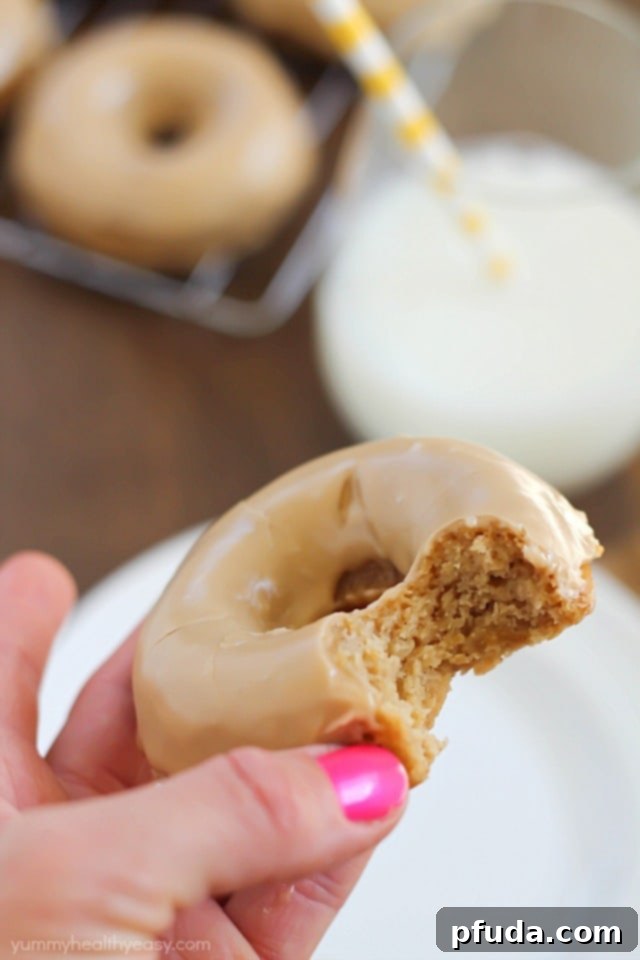 These Baked Apple Donuts with Maple Glaze are seriously the best baked donuts ever! Moist, apple-spiced flavor dipped in the tastiest maple glaze known to man. And only 196 calories per donut! 