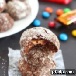 Chocolate Surprise Crinkle Cookies filled with pieces of your favorite candy inside and rolled in powdered sugar - the best way to use up any leftover candy!