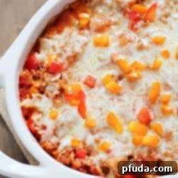 Casserole dish filled with deconstructed stuffed peppers, topped with melted cheese.