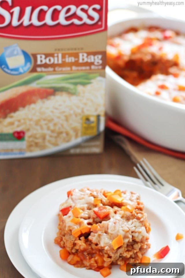 A top-down view of the freshly baked Stuffed Bell Pepper Casserole, showcasing its golden, melted cheese topping and the hearty, colorful ingredients beneath.