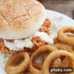 Crock Pot Buffalo Chicken Sandwiches - a close-up of a serving with toppings