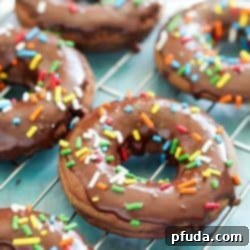 Soft and light baked chocolate cake donut topped with rich chocolate glaze and colorful sprinkles, made with Real California Milk.