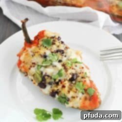 Southwestern Quinoa Stuffed Peppers Recipe - pasilla peppers filled with black beans, quinoa and spices then cooked in a flavorful tomato sauce. Vegetarian, gluten free, clean-eating and absolutely delicious!