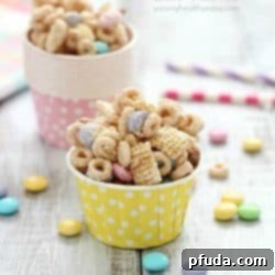 Super delicious and easy Bunny Bait aka Easter Snack Mix. Made with cereal, pretzels, peanuts, pastel M&M candies and white chocolate - perfect for Easter!