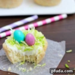 Need a fun treat to make for an Easter get together? Make these darling Easter Nest Sugar Cookie Cups! Sugar cookie dough cooked in a muffin tin, filled with vanilla frosting, topped with green tinted coconut and M&M eggs to look like a little bird's nest. So cute and great for spring! #truvia