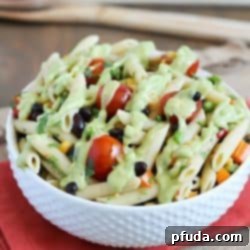 Fiesta Pasta Salad 2 A simply delicious side dish, Mexican Pasta Salad - with black beans, corn, bell pepper, cilantro, tomatoes, and an avocado dressing.