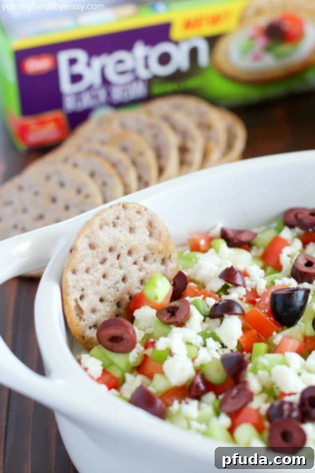 Wholesome Gluten-Free Greek Delight 3 Deliciously healthy greek dip, made with a protein-rich cottage cheese base (with ranch seasonings!) then topped with cucumbers, green onions, tomatoes, kalamata olives, and feta cheese. Healthy and full of flavor! #breton #ad