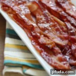 Crispy Caramelized Bacon 2 Brown Sugar Bacon aka Candied Bacon aka the Best Bacon EVER! This easy bacon is baked in the oven with a topping of brown sugar and pepper, and comes out sticky, sweet & savory. Absolutely drool-worthy!