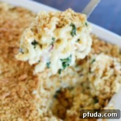 A delicious serving of Baked Macaroni and Cheese Casserole made with Sargento Chef Blends 4 State Cheddar, bacon, and kale, topped with crushed oyster crackers.