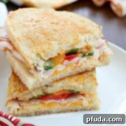 Delicious Southwestern Grilled Turkey and Cheese Sandwich halves on a cutting board