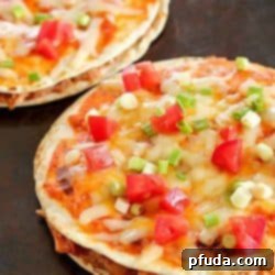 Tray with two Mexican Pizzas. Easy, yummy recipe of layered flour tortillas with a filling of refried beans, shredded chicken and salsa.