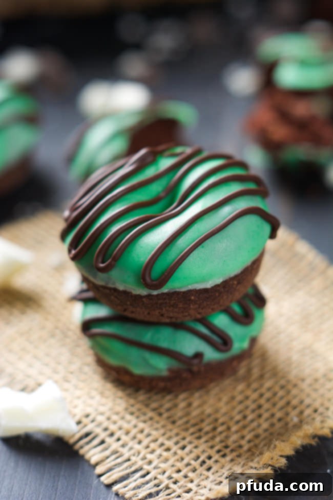Mini Thin Mint Donuts, tender chocolate donuts with mint white chocolate icing and chocolate drizzle, inspired by the classic cookie.