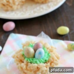Easy Rice Krispies Easter Nests recipe card image, featuring a close-up of a decorated nest.